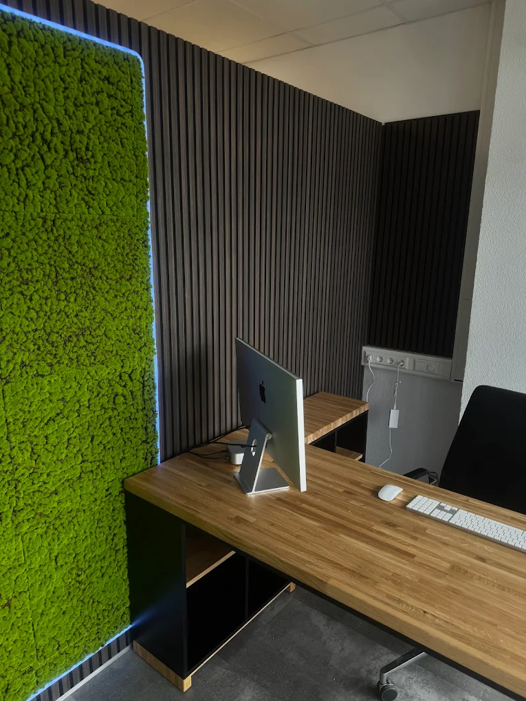 Un bureau d'angle adossé à un mur végétalisé de mousse pour l'auto-école ZERO de Friedrichshafen (Allemagne)